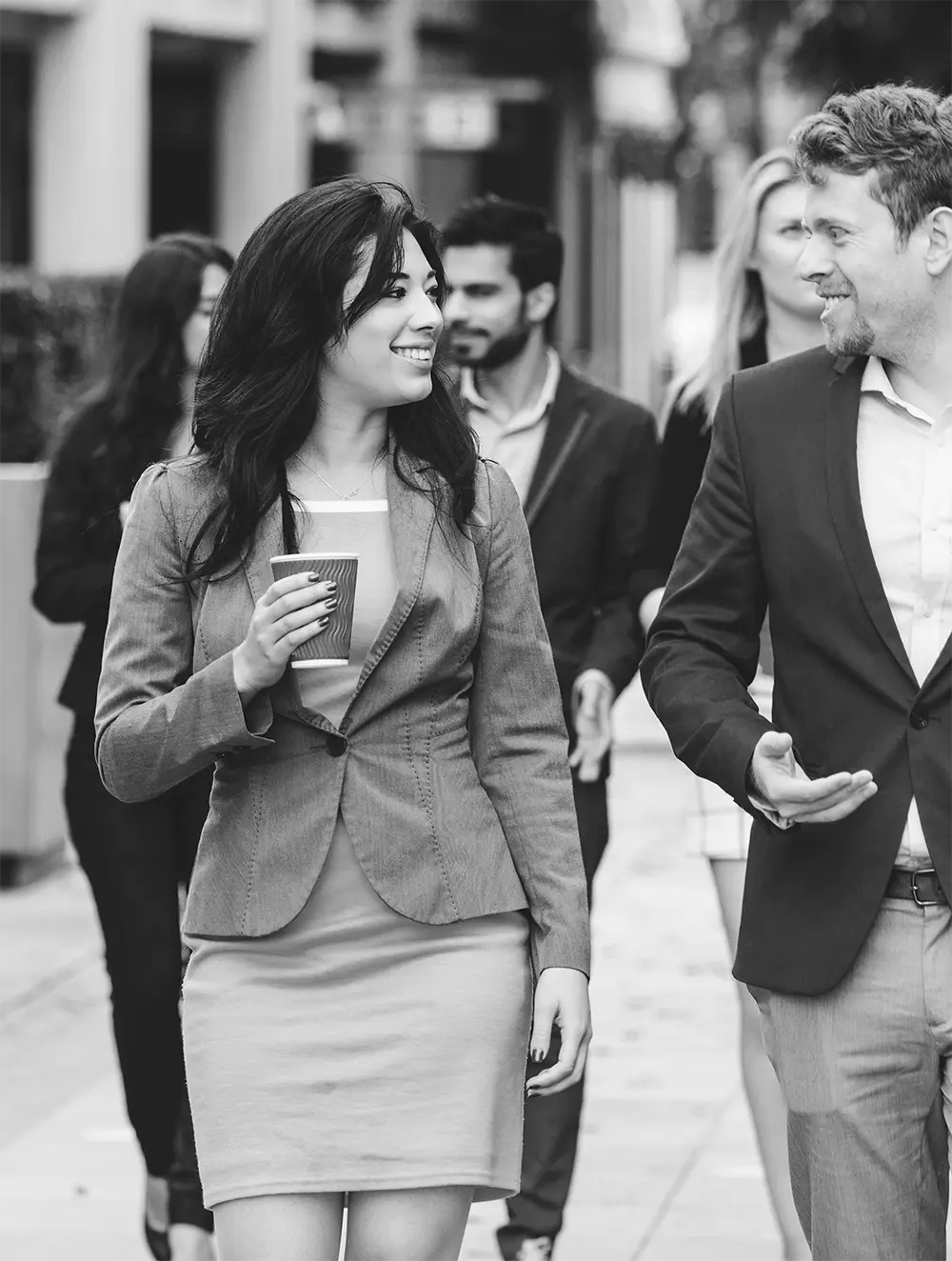 a group of people walking outside the office